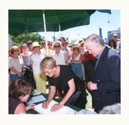 a photograph of Hazel Hawke and Bryce Courtenay signing Sorry Book