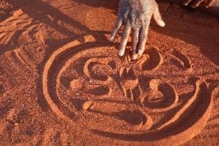 Drawing symbols in a sand story. Photo: Jennifer Green Drawing symbols in a sand story. Photo: Jennifer Green